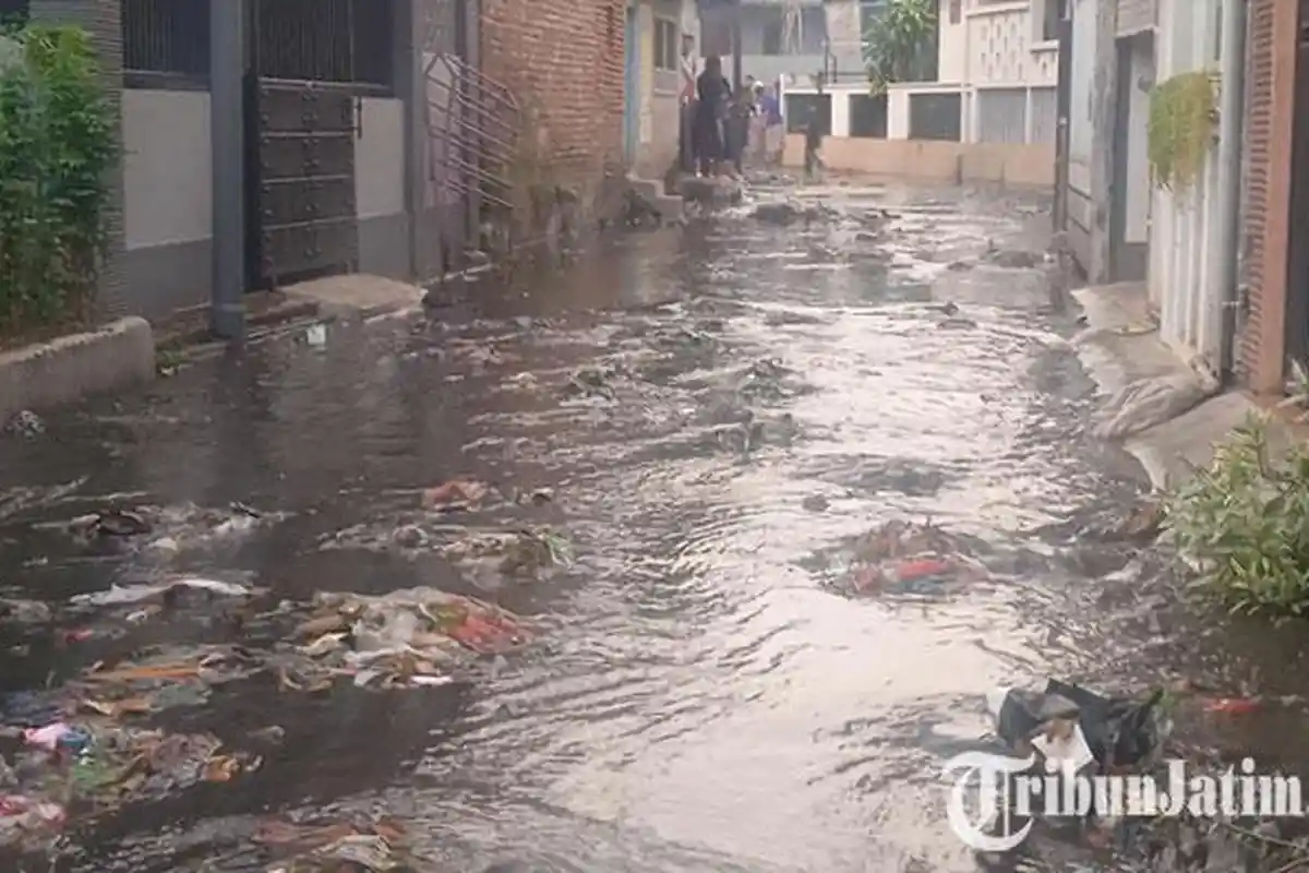 Air Selokan di Kaliwates Jember Meluap Genangi Jalan, Berwarna Keruh dan Bawa Tumpukan Sampah