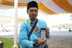 20260508-Jamaah-Haji-Indonesia-memperlihatkan-tampilan-BPKH-Apps.jpg