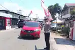 POLANTAS-Seorang-anggota-polantas-Kota-Gorontalo-mengantur-lalu-lintas-Sabtu-28-Maret-2026.jpg