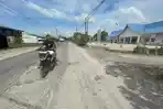 JALAN-RUSAK-Pengendara-sepeda-motor-melintas.jpg