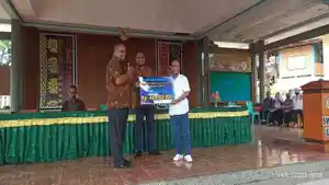Senator-Angelius-Wake-Kako-saat-menyerahkan-bantuan-uang-kepada-kepala-SMA-Negeri-1-Ende.jpg