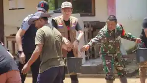 Bupati-Bolsel-Iskandar-Kamaru-saat-membersihkan-banjir-di-dua-kecamatan.jpg
