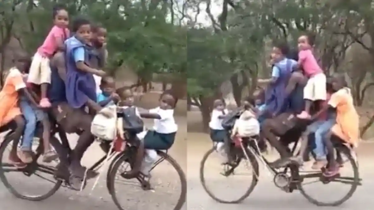 VIRAL Pria Mengendarai Sepeda Bersama 9 Anak, Ada yang Digendong hingga Duduk di Roda Depan