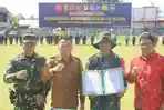 Bupati-Ronald-Kandoli-saat-menghadiri-upacara-penutupan-TMMD-ke-128-tahun-2026.jpg
