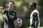 Xabi-Alonso-memberikan-arahan-kepada-Vinicius-Junior-dalam-latihan-bersama-skuad-Real-Madrid.jpg