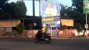 Baliho-bertuliskan-pasangan-Aji-Rum-dan-Umi-Innah-Amanah-menuju-Kota-Bima-Baru-te.jpg